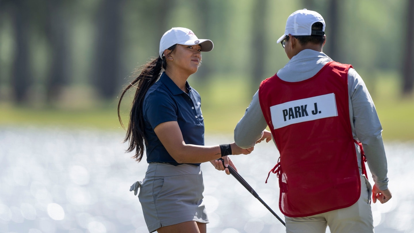 Jennie park and her caddie jimmy lee after putting on hole no 18 during